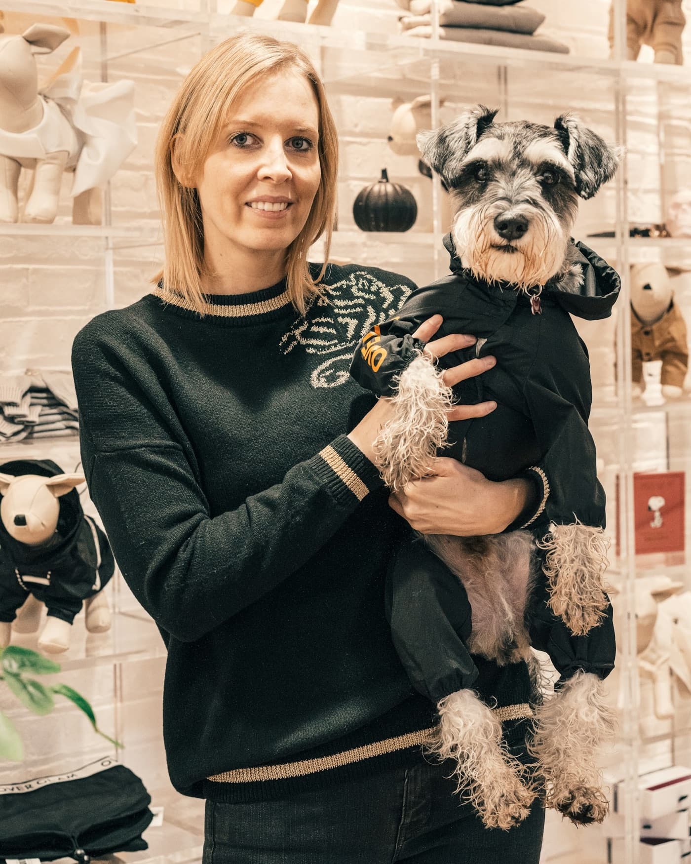 Pet retail professional holding a miniature schnauzer